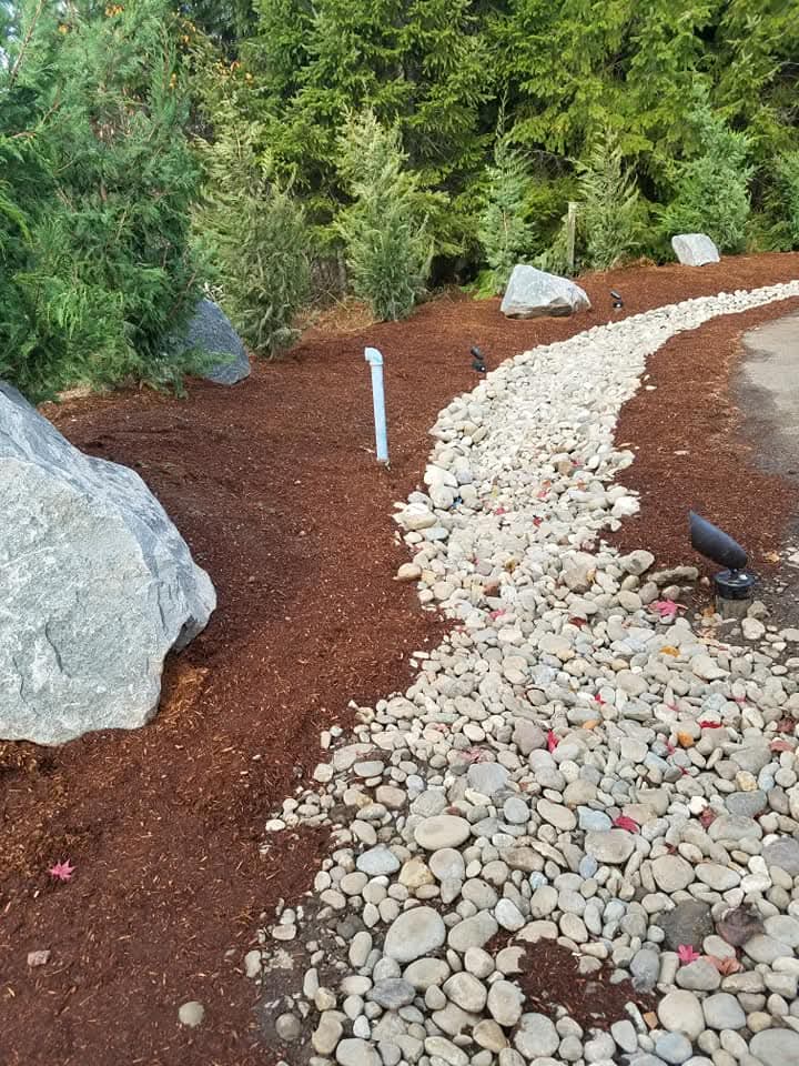 River rock drainage landscape by Morales Landscaping